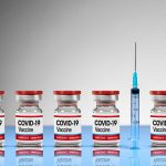COVID-19 vaccine vials with syringe