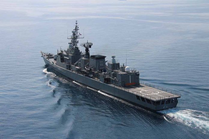 1611527764 featured image Navy frigate sailing on calm ocean waters.