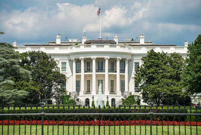 1198847647 featured image White building with columns behind a black fence.