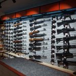 Wall display of various rifles in a gun store.
