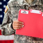 U.S. Army soldier holds a "Top Secret" folder.