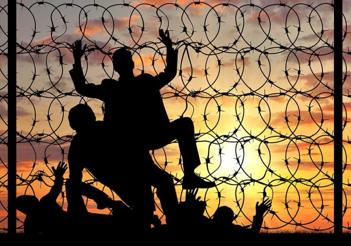 334479050 featured image Silhouettes and barbed wire against sunset sky backdrop