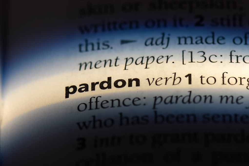 1155434380 featured image The word "pardon" highlighted in a dictionary.