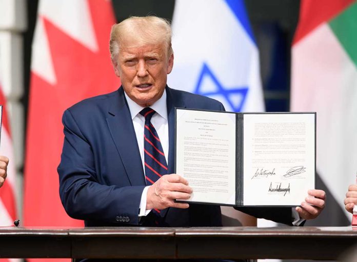 1816392461 featured image Person in blue suit holding signed document in ceremony