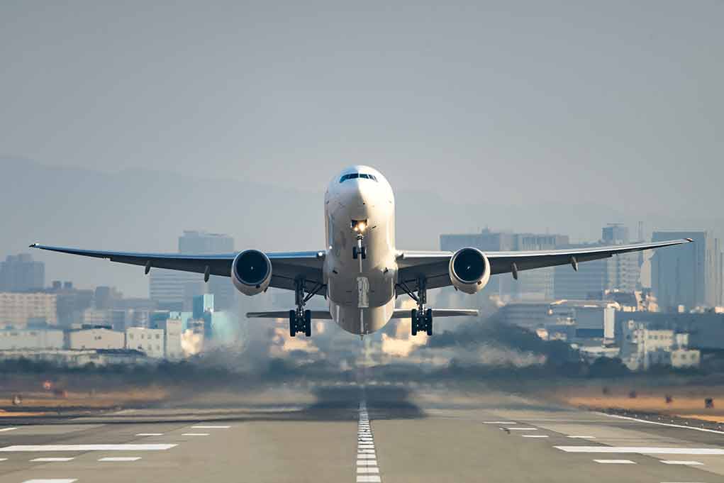 559714906 featured image Airplane taking off from runway in urban area