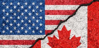USA and Canada flags divided by a crack