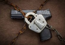 Gun secured with chains and padlock on fabric