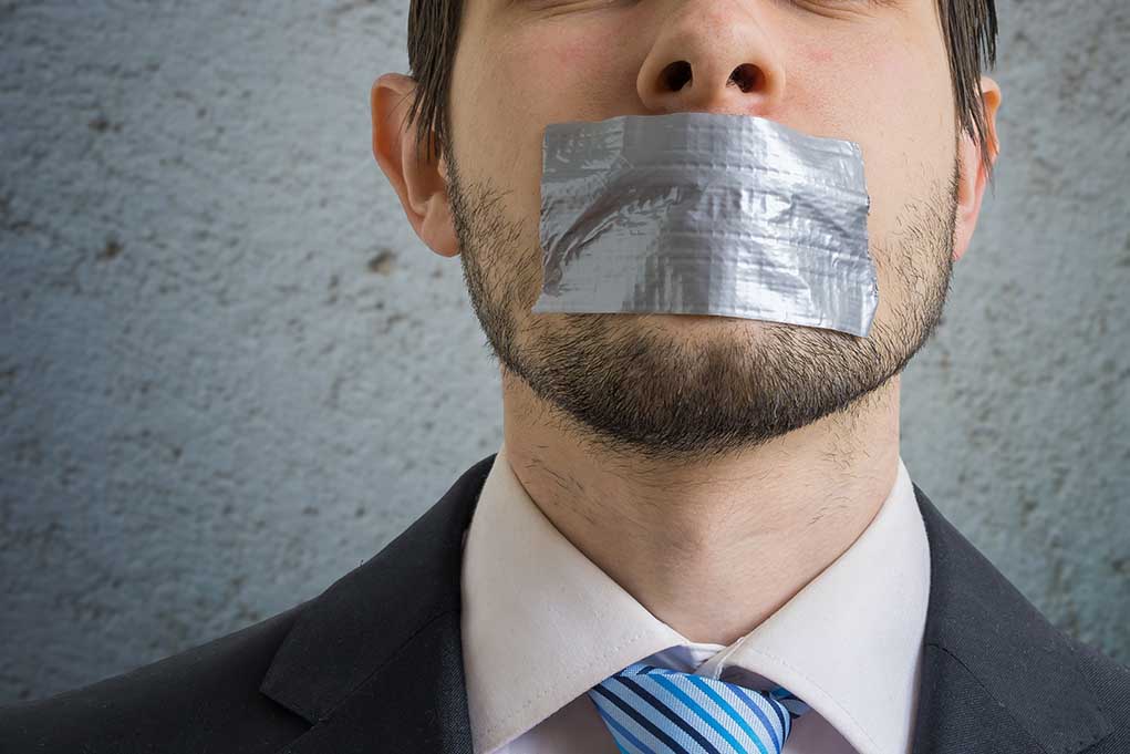 566889316 featured image Person with duct tape over mouth in suit
