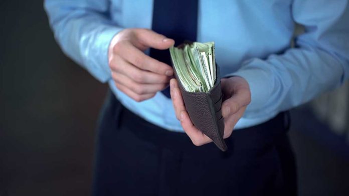 1263203449 featured image Person holding wallet filled with cash in hands