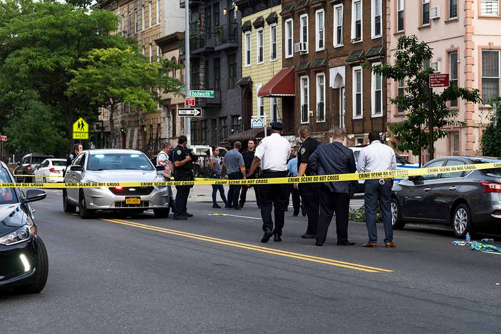 1437619223 featured image Police gathered at an urban crime scene.