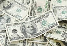 Pile of US hundred dollar bills