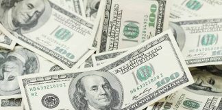 Pile of US hundred dollar bills