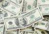 Pile of US hundred dollar bills