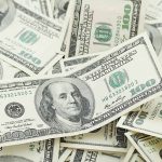 Pile of US hundred dollar bills