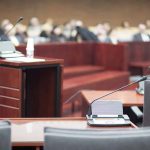 Empty courtroom with microphones and a podium