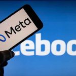 Meta logo on phone, Facebook background display.