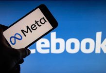 Meta logo on phone, Facebook background display.