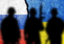Three soldier silhouettes against split Russia Ukraine flags