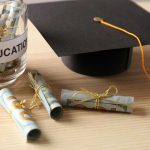 Graduation cap with money rolls and jar labeled Education.