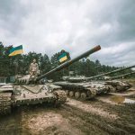 Tanks with flags in muddy forest environment