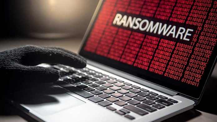 1141202159 featured image Gloved hand on laptop with ransomware screen
