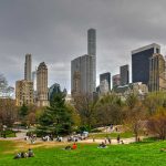 City skyline with park and people relaxing
