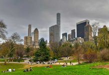City skyline with park and people relaxing