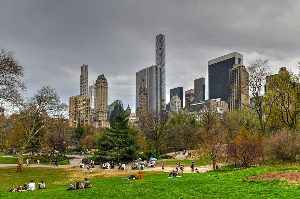 City skyline with park and people relaxing