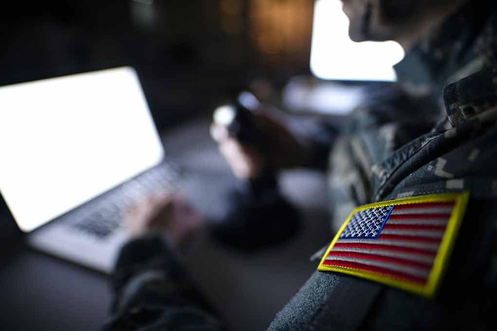 1395036650 featured image Soldier using laptop with US flag patch visible