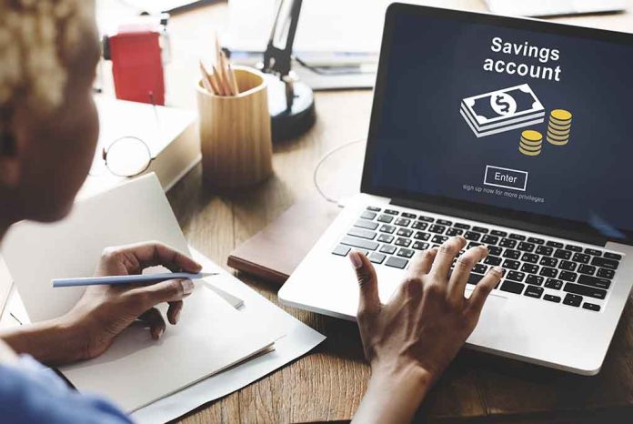 403453867 featured image Person using laptop savings account application