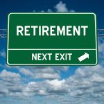 Green road sign reading retirement next exit sky background