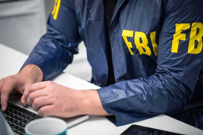629482379 featured image Person in FBI jacket typing on a laptop