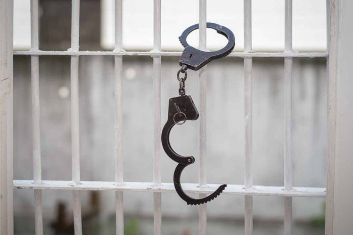 680970664 featured image Open handcuff hanging on white prison bars