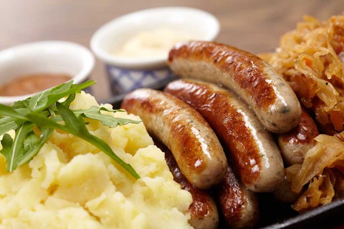 101880892 featured image Sausages mashed potatoes sauerkraut and sauces on plate