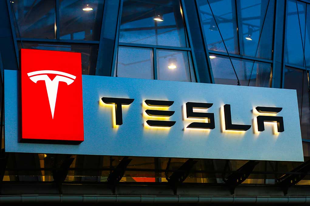 Tesla logo on a building at night