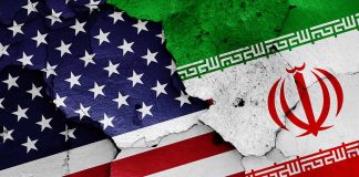 Cracked American and Iranian flags painted on a wall
