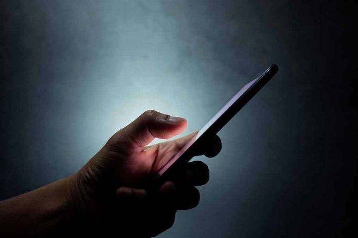 1431658976 featured image Hand holding a smartphone in the dark