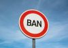 Sign with word BAN against clear sky