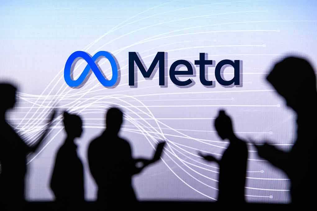 People silhouetted against Meta logo background