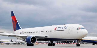 Delta Airlines airplane on airport runway cloudy sky