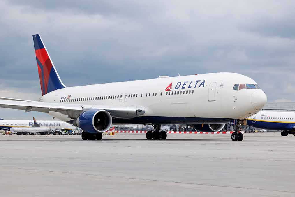 2305553471 featured image Delta Airlines airplane on airport runway cloudy sky