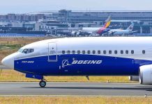 Boeing 737 800 on airport runway with other planes