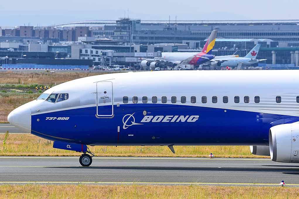 2406303801 featured image Boeing 737 800 on airport runway with other planes