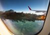Airplane wing with engine on fire mid flight