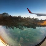 Airplane wing with engine on fire mid flight