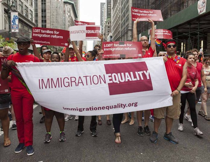 525426433 featured image Group holding IMMIGRATION EQUALITY banner at a parade