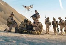 Soldiers operating a drone in a desert environment