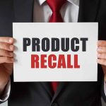 Product Recall sign held by person in suit