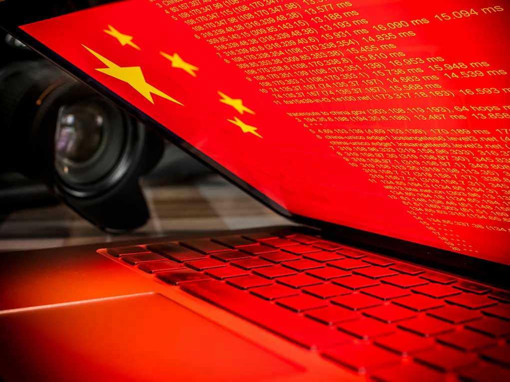 1261948831 Laptop screen displaying Chinese flag and code.