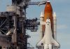 Space shuttle on launch pad with support structure